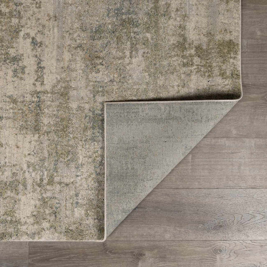 Close-up of the Zazie Thick Luxe Rug showing its beige, gray, and olive abstract pattern and machine-woven construction. Fold