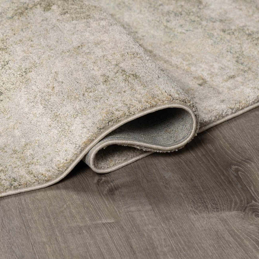 Close up of the beige and gray Zazie Thick Luxe Rug showing its plush texture and backing. Fold