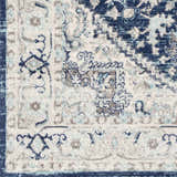 Close-up of the Livabliss Chester rug. Machine woven polypropylene rug in beige, charcoal, navy, and sky blue. Farmhouse style. Swatch