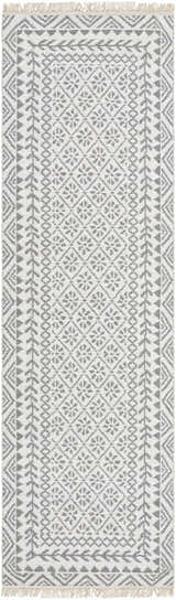 Close-up of the hand woven Bayou Area Rug. Features a gray and beige farmhouse-style geometric pattern and tasseled edges. Design-Runner-268