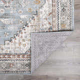 Close-up of the Kouta Gray Blue Area Rug showing its traditional pattern, soft texture, and durable machine-woven construction. Fold