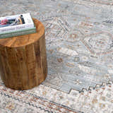 Close-up of the Kouta Gray Blue Area Rug, showcasing its traditional pattern, ice blue, beige, and brown colors. Styleshot