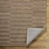 Close-up of the hand-tufted Idaho Broken-Striped Brown Area Rug. Beige, sandstone, and taupe wool rug with a broken striped pattern. Fold