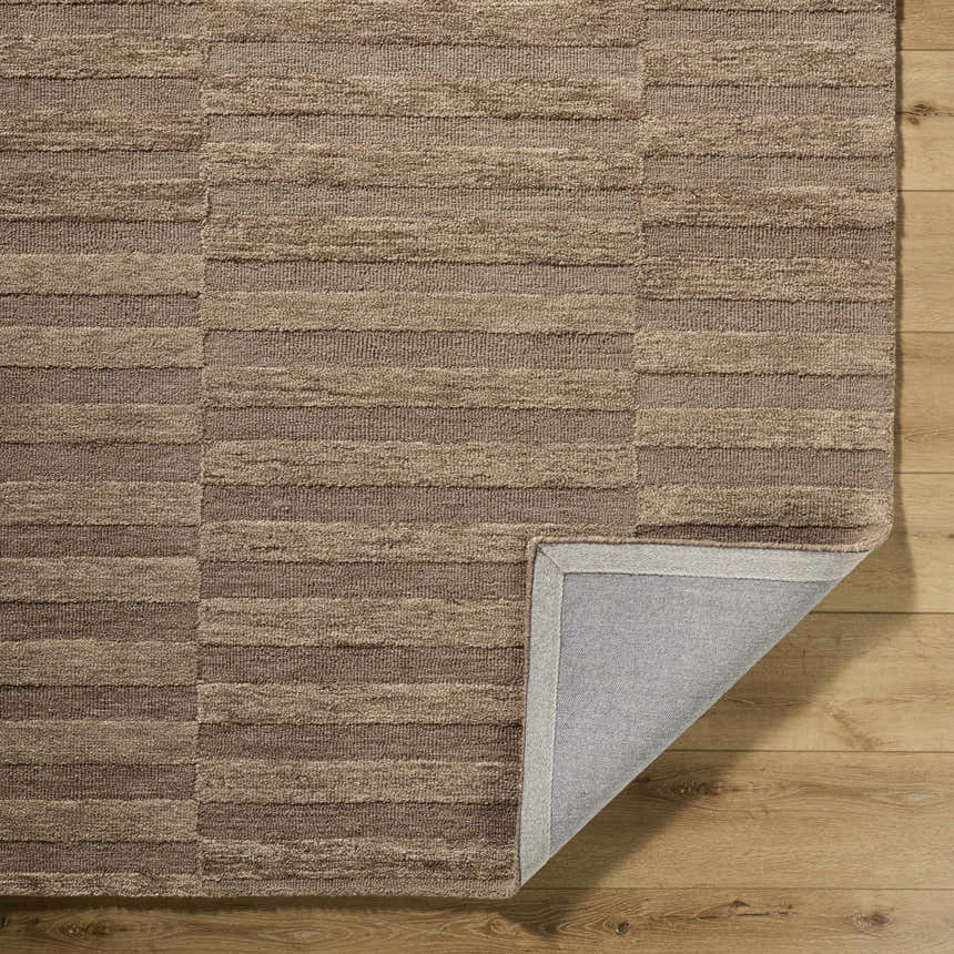 Close-up of the hand-tufted Idaho Broken-Striped Brown Area Rug. Beige, sandstone, and taupe wool rug with a broken striped pattern. Fold