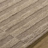 Close-up of the Idaho Broken-Striped Brown Area Rug. Beige, sandstone, and taupe wool rug with a textured, broken stripe pattern. Texture