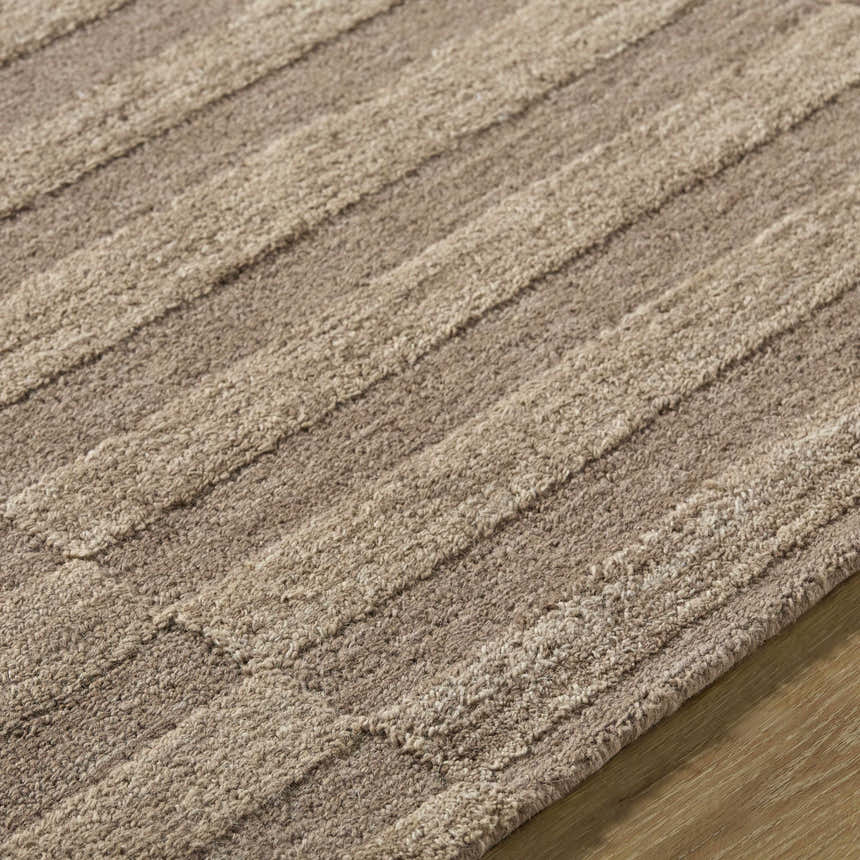 Close-up of the Idaho Broken-Striped Brown Area Rug. Beige, sandstone, and taupe wool rug with a textured, broken stripe pattern. Texture