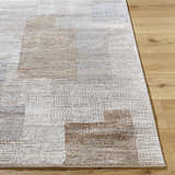 Close-up of the Anaisa Beige Luxe Thick Area Rug. Geometric pattern in ivory, tan, and brown tones. Soft, plush texture. Front