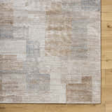 Close up of the Anaisa Beige Luxe Thick Area Rug, showing geometric pattern and soft texture on wood floor. Swatch