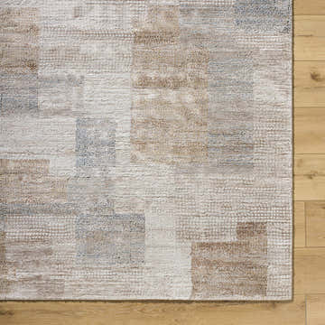 Close up of the Anaisa Beige Luxe Thick Area Rug, showing geometric pattern and soft texture on wood floor. Swatch