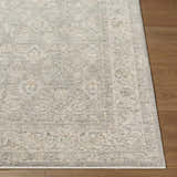 Close-up of the Buddug Cream Area Rug showing its farmhouse style pattern and texture on a wood floor. Front