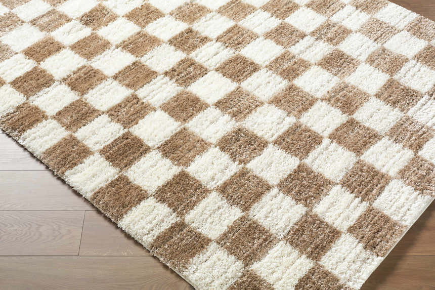 Close-up of Belita Cream Luxe Shag Area Rug with a tan and ivory checkerboard pattern and soft, plush texture. Corner
