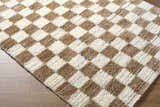 Close-up of the Belita Cream Luxe Shag Area Rug featuring a cream and tan checkerboard pattern and plush texture. Corner