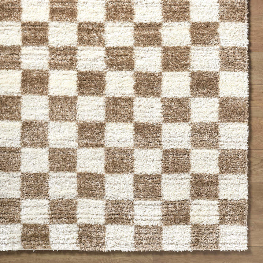 Close up of Belita Cream Luxe Shag Area Rug showing checkered cream and tan pattern and soft shag texture. Corner