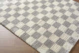Close up of Belita Tan Luxe Shag Area Rug showing cream and light gray checkered pattern and soft, plush texture. Corner
