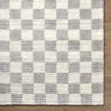 Close up of Belita Tan Luxe Shag Area Rug; cream and light gray checkerboard pattern, soft shag texture. Corner
