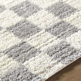 Close-up of Belita Tan Luxe Shag Area Rug featuring a striped pattern in cream, light gray, and tan. Soft, plush texture. Texture