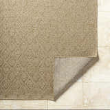 Close-up of the Bandit Brown Area Rug showing its camel color, geometric pattern, and textured, machine-woven construction. Fold