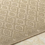 Close-up of Bandit Brown area rug showing diamond geometric pattern and woven texture in camel, tan, and prairie dust hues. Texture