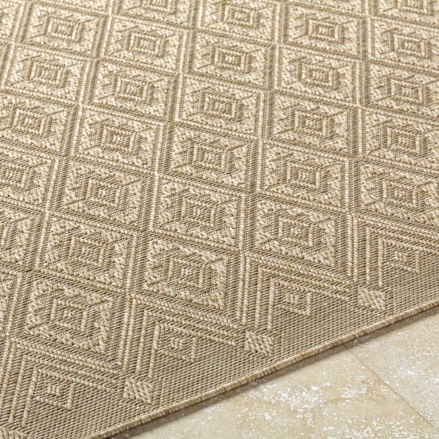 Close-up of Bandit Brown area rug showing diamond geometric pattern and woven texture in camel, tan, and prairie dust hues. Texture