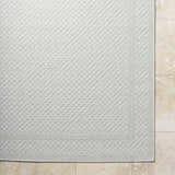 Close-up of the light silver Brinda Area Rug showing its woven texture and contemporary pattern. Corner