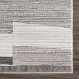 Close up of Bojana Broken-Striped Area Rug. Geometric design in black, cream, off white, and vizon. Machine woven texture. Swatch
