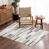 Living room scene with Bojana Broken-Striped Area Rug, wood chair, and cabinet. Modern geometric design. Roomscene-Rectangle