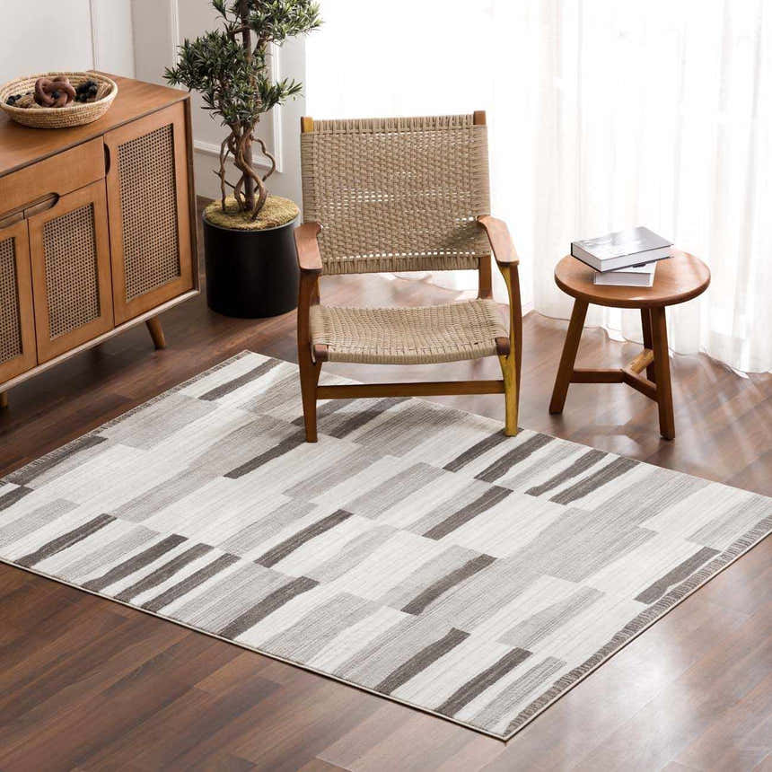 Living room scene with Bojana Broken-Striped Area Rug, wood chair, and cabinet. Modern geometric design. Roomscene-Rectangle