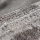 Close-up of the soft, textured pile of the Bojana Broken-Striped Area Rug in cream, off-white, black, and vizon. Texture
