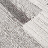 Close-up of the Bojana Broken-Striped Area Rug showing its cream, off-white, vizon, and black geometric pattern and soft texture. Texture