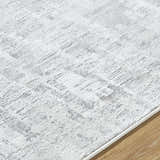 Close up of the Branka Area Rug, showing a contemporary light silver and gray pattern. Texture