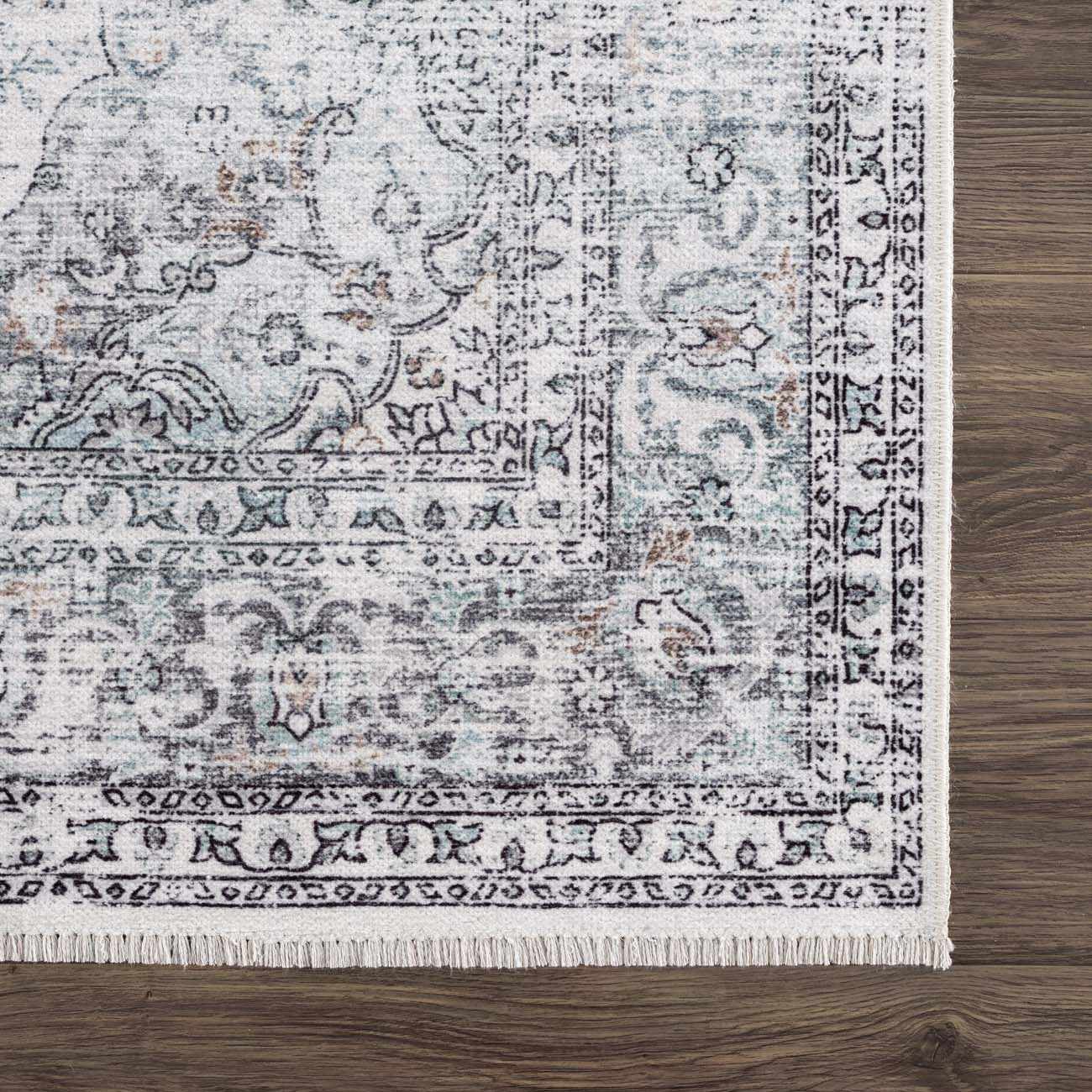 Close-up of the Light Blue Holi-4603 Washable Area Rug. Traditional vintage style with charcoal, light blue, and brown tones. Swatch