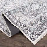 Close-up of the Light Blue Holi-4603 Washable Area Rug, featuring a traditional vintage pattern and charcoal, blue, and gray tones. Fold