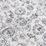 Close-up of the Light Blue Holi-4603 Washable Area Rug. Features a traditional floral pattern in light blue, gray, and brown tones. Texture