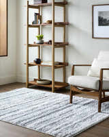 Living room scene with a cream chair and Blaise Area Rug in cream and gray. Contemporary style. Roomscene-Rectangle