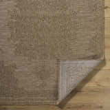 Close-up of the beige Bahula Area Rug showing its traditional floral pattern and machine-woven texture. Fold