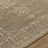 Close-up of the beige Bahula Area Rug showing its traditional woven pattern and texture. Texture