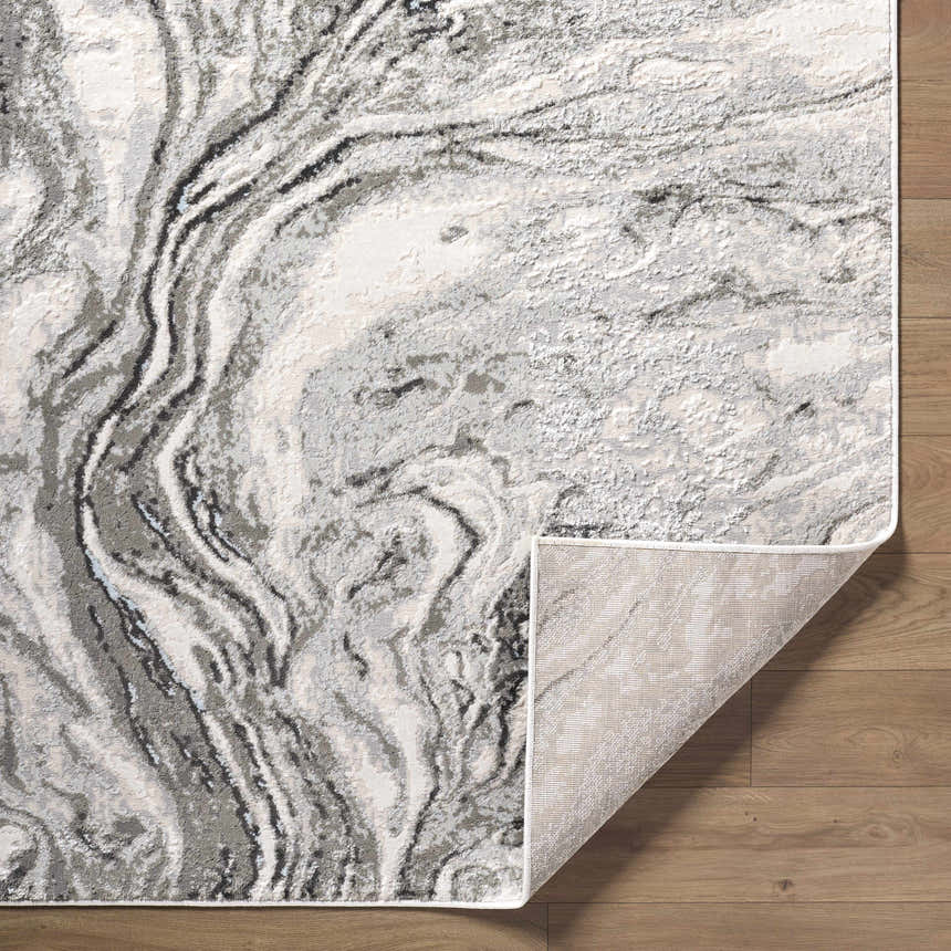 Close-up of the Brandi Gray Marble Area Rug featuring beige, cream, and gray marble-like design and folded corner. Fold
