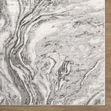 Close-up of Brandi Gray Marble Area Rug featuring a contemporary beige, cream, and gray marble-like pattern. Corner