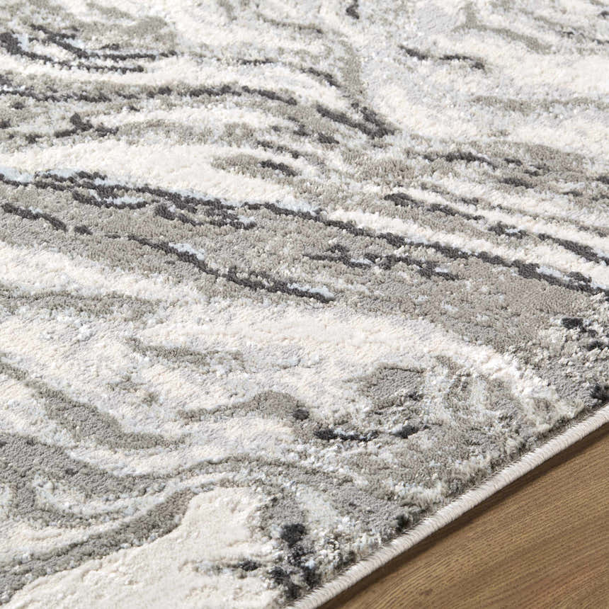 Close up of the Brandi Gray Marble Area Rug featuring a contemporary gray, cream, and beige marble pattern. Texture