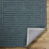 Close up of the slate blue Birger Area Rug showing the textured, contemporary block pattern and wool material. Fold