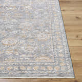 Close-up of the machine-woven Bayram Area Rug. Gray, ivory, and taupe floral pattern on a soft polyester rug. Front