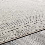 Close-up of the Livabliss Bahar BHR-2321 area rug, showing its off-white base and charcoal geometric pattern. Texture