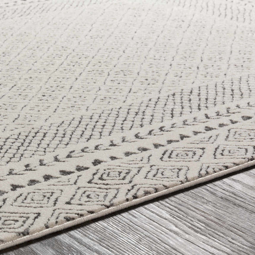 Close-up of the Livabliss Bahar BHR-2321 area rug, showing its off-white base and charcoal geometric pattern. Texture