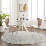 Bright dining room with round white table and Livabliss Bahar BHR-2321 area rug in charcoal and off white. Roomscene-Round