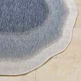 Close-up of the woven texture and wavy edge of the Burian Blue Area Rug in blue, cream, and navy. Front
