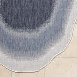 Close-up of the machine woven Burian Blue Area Rug showing blue, cream, and navy hues and polypropylene texture. Corner