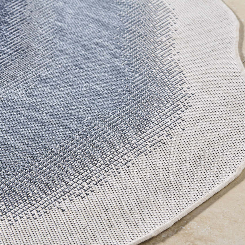 Close-up of the machine woven Burian Blue Area Rug showing the blue and cream farmhouse style pattern and texture. Texture