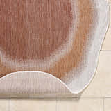 Close-up of the Burian Orange Area Rug showing burnt orange, cream, and rust colors and machine-woven texture. Fold