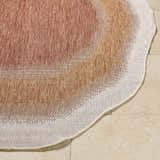 Close-up of the Burian Orange Area Rug showing burnt orange, cream, and rust tones. Machine woven texture. Front