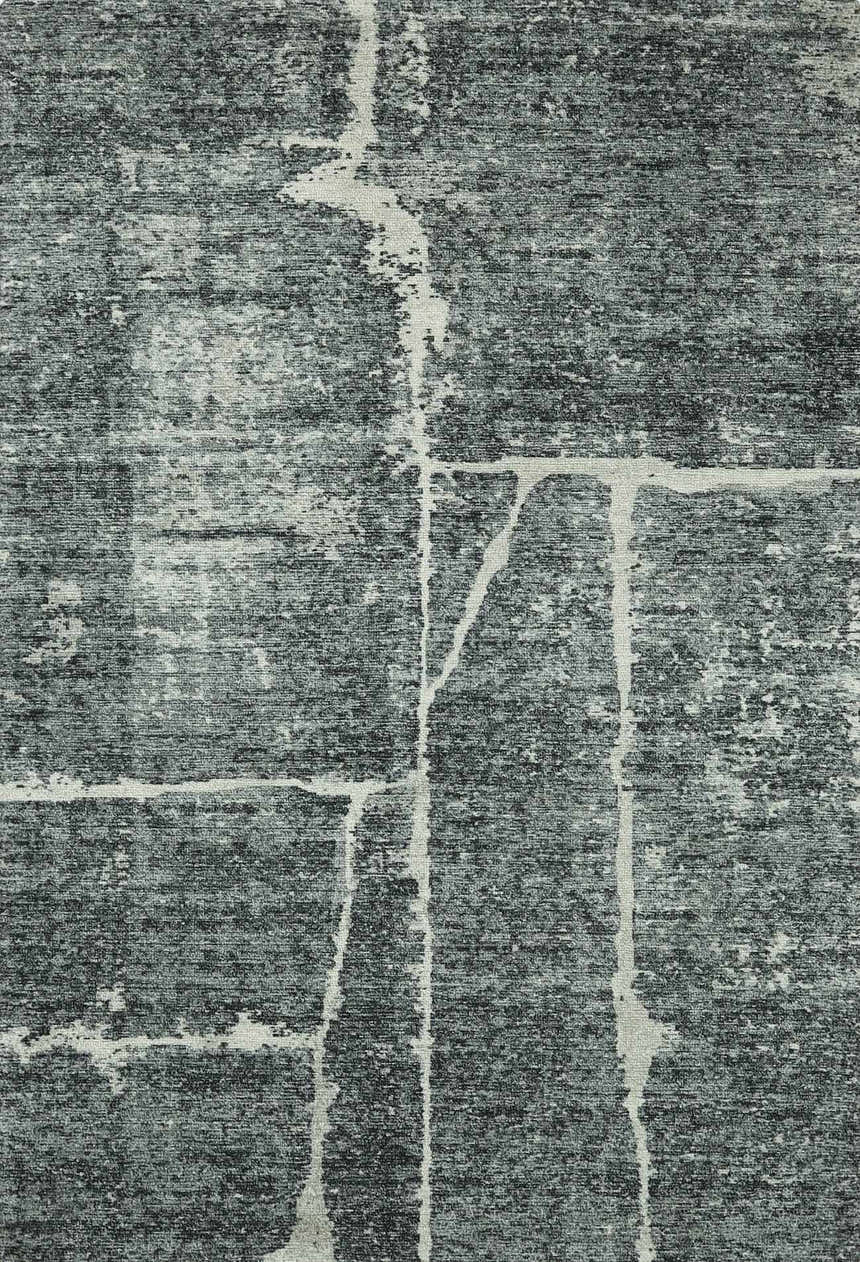 Close-up of the Janek II Modern Abstract Area Rug. Hand-tufted polyester rug in shades of gray with a white abstract pattern. Design-Rectangle